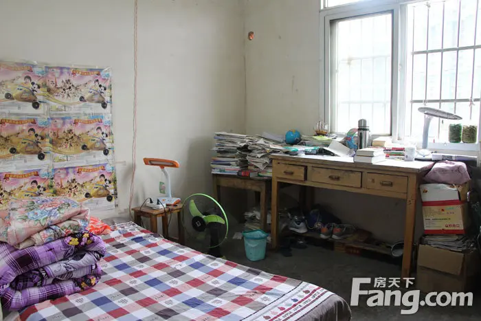 王淼的出租屋内一张破旧的床和书桌